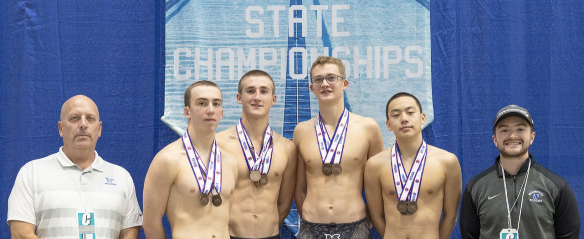 Boys swim team holding their medals